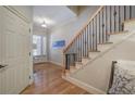 Elegant staircase with hardwood steps and wrought iron railing at 5492 Glenridge Dr # 536, Atlanta, GA 30342