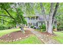 Charming two-story home with stone walkway, beautiful lawn, and mature trees at 2041 Millspring Nw Way, Kennesaw, GA 30152