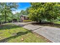 Long driveway leading to a well-maintained home with ample parking and a detached garage at 6863 Recreation Ln, Acworth, GA 30102