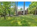 Inviting single-story home featuring a front porch and well-manicured lawn with mature trees at 6863 Recreation Ln, Acworth, GA 30102