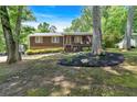 Quaint single-story home boasts a cozy front porch and meticulously maintained landscaped yard at 6863 Recreation Ln, Acworth, GA 30102