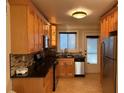 Well-equipped kitchen boasting stainless steel appliances, a stylish backsplash, and wooden cabinets at 375 6Th Ne St # 5, Atlanta, GA 30308