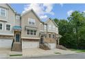 Inviting townhomes feature brick accents, individual garages, and manicured landscaping at 4173 Chatham Ridge Dr, Buford, GA 30518