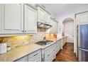Stylish kitchen equipped with a gas cooktop, tiled backsplash, and ample counter space at 238 Trecastle Sq, Canton, GA 30114