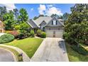 Inviting single Gathering home featuring a manicured lawn, charming curb appeal, and a 2-car garage at 4251 Lantern Hill Dr, Dacula, GA 30019
