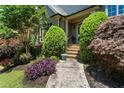 Inviting front entrance featuring well manicured landscaping, colorful plants and inviting steps at 4251 Lantern Hill Dr, Dacula, GA 30019