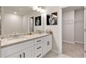 Bathroom with granite countertops, double sinks, walk-in closet, and decorative wall art at 181 Dewy Rd # 70, Lilburn, GA 30047