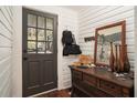 Welcoming entryway featuring a stylish door, wooden floors, and antique furnishings at 2 N Broad St, Porterdale, GA 30070