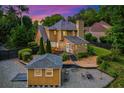 Backyard featuring a deck, enclosed porch, outbuilding and gravel patio area at 2366 Battle Forest Sw Dr, Marietta, GA 30064