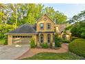 Charming stucco home with a lush landscaped yard and a two-car garage at 2366 Battle Forest Sw Dr, Marietta, GA 30064