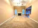 Spacious living room with high ceilings, a cozy fireplace, and large windows that bring in natural light at 6745 Fairfield Trce, Suwanee, GA 30024