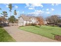 Side view of home with a two-car garage and a long driveway at 1495 Oak Springs Dr, Marietta, GA 30066