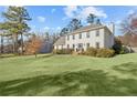 Expansive green lawn in front of this two-story home with a brick entry at 1495 Oak Springs Dr, Marietta, GA 30066