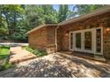 Stone facade featuring a wooden walkway, stained glass sidelights and stone patio at 1690 Trotters Ln, Stone Mountain, GA 30087