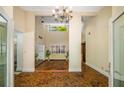 Foyer with herringbone brick floors, chandelier, and views of multiple rooms in the home at 1690 Trotters Ln, Stone Mountain, GA 30087