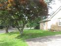Brick house with a healthy green lawn and mature trees offering shade and curb appeal at 2447 Omaha Sw Rd, Atlanta, GA 30331