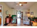 Open living room with hardwood floors, ceiling fan, comfortable seating, and natural light at 2465 Planters Cove Cir, Lawrenceville, GA 30044