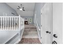 Bright, open living room featuring a vaulted ceiling, ceiling fan, and a cozy fireplace at 5640 Rolling Oaks Dr, Cumming, GA 30040