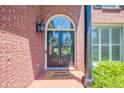 Inviting entryway featuring a double front door, brick facade, and decorative wreath accents at 7045 Grand View Way, Suwanee, GA 30024