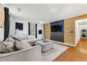 Modern living room boasts stylish accent wall, wooden floors, and comfortable seating at 1357 Railroad Ave, Sugar Hill, GA 30518