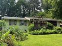 Charming single-story home featuring a welcoming front porch, lush landscaping, and a well-maintained lawn at 3291 Shady Oak Dr, Atlanta, GA 30340