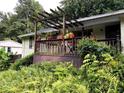 Relaxing wooden porch with pergola, potted plants, and a view of the surrounding lush landscaping at 3291 Shady Oak Dr, Atlanta, GA 30340