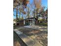 Exterior view of a brick home with a concrete driveway and natural landscaping at 4510 Burks Rd, Forest Park, GA 30297