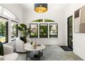 Bright living room with white brick walls, arched windows, and stylish decor at 570 Martina Ne Dr, Atlanta, GA 30305