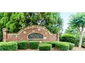 Stone and brick entrance sign for the Avonley Creek community amidst lush landscaping at 779 Avonley Creek Trce, Sugar Hill, GA 30518