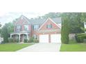 Beautiful two-story brick home with an attached two-car garage and well-kept landscaping at 779 Avonley Creek Trce, Sugar Hill, GA 30518