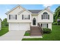 Inviting exterior of a two-story home with light siding, black shutters, a well-manicured lawn, and an attached two-car garage at 11072 Pebble Ridge Dr, Hampton, GA 30228