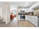 Eat-in kitchen features white cabinets, granite countertops, and stainless-steel appliances at 11072 Pebble Ridge Dr, Hampton, GA 30228