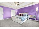 Spacious main bedroom with tray ceiling, carpet flooring and ensuite bathroom at 11072 Pebble Ridge Dr, Hampton, GA 30228