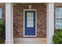 Close-up of front door with glass panel and white trim columns around the brick entrance at 1433 Sand Way, Lawrenceville, GA 30045