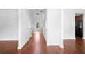 Bright hallway with wood flooring, white walls and multiple doors on either side at 1433 Sand Way, Lawrenceville, GA 30045