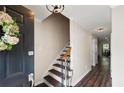 Bright foyer with hardwood floors, staircase and black front door at 1223 Whitlock Ridge Sw Dr, Marietta, GA 30064