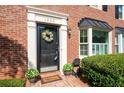 Inviting front door with wreath, set in a brick facade with manicured shrubs at 1223 Whitlock Ridge Sw Dr, Marietta, GA 30064