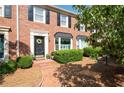 Well-maintained brick townhome boasts classic architectural details and manicured landscaping at 1223 Whitlock Ridge Sw Dr, Marietta, GA 30064
