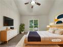 Serene bedroom with vaulted ceilings, a large window, and modern furnishings offers a comfortable retreat at 339 Warrenton Dr, Douglasville, GA 30134
