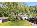 Charming two-story home featuring an attached garage, mature landscaping, and an inviting front entrance at 4256 Village Square Ln, Stone Mountain, GA 30083