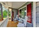 Inviting front porch with rocking chairs, and red shutters at 190 Grayland Creek Dr, Lawrenceville, GA 30046