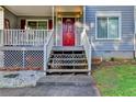 Charming front porch entry with a bright red door, steps, and a white railing at 190 Grayland Creek Dr, Lawrenceville, GA 30046