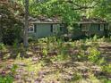 Quaint single-story home with a wooded front yard, perfect for nature lovers at 225 Oglesby Bridge Rd Se, Conyers, GA 30094