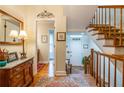 Entryway foyer featuring hardwood floors, staircase, and decorative mirror at 3833 Savannah E Sq, Atlanta, GA 30340