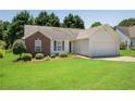 Charming single-story home with a brick accent, manicured lawn, and attached two-car garage at 424 Yellow River Walk, Lawrenceville, GA 30043