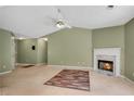 Living room with neutral carpet, a fireplace with marble surround, and overhead ceiling fan at 424 Yellow River Walk, Lawrenceville, GA 30043