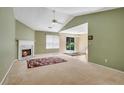 Spacious living room with a fireplace, vaulted ceilings, and sliding glass door to the outside at 424 Yellow River Walk, Lawrenceville, GA 30043