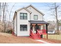 Attractive two-story home showcasing a combination of brick and siding, complemented by a charming front porch at 4041 Blanton Sw Ave, Atlanta, GA 30331
