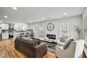Bright living room with hardwood floors, modern fireplace, and open floor plan to kitchen at 4041 Blanton Sw Ave, Atlanta, GA 30331
