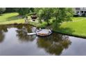 Lakefront property with a wooden dock, seating, and a kayak, perfect for enjoying waterfront living at 625 W Lake Dr, Oxford, GA 30054